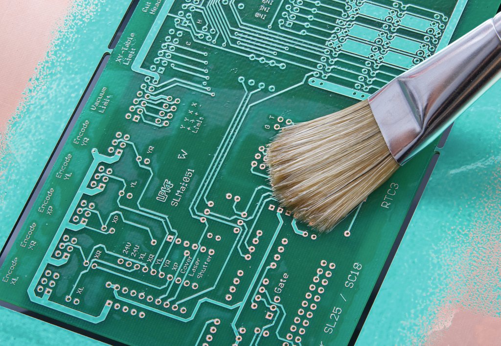 Conformal coating material being applied to pcb via brush