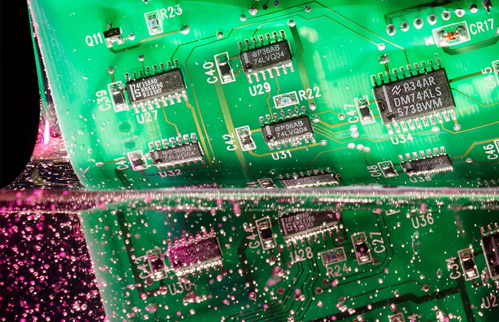 Pcb being dipped into a liquid conformal coating